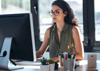 Shot of concentrated young business woman working with computer in the office.
